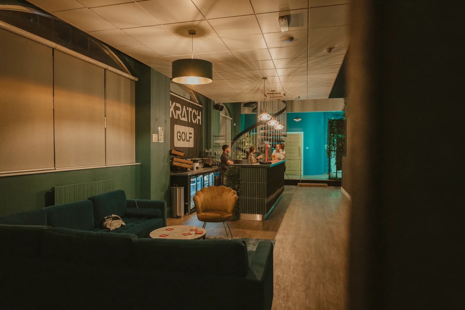 The SKRATCH lounge with sofas and lamps, the bar in the distance